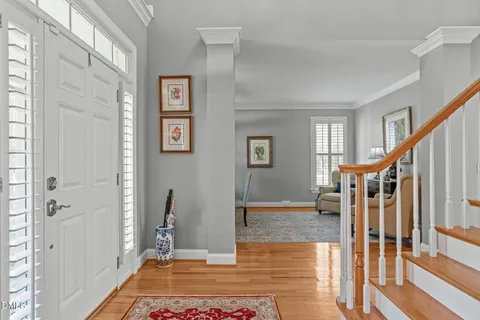 a dining room with furniture a chandelier and wooden floor