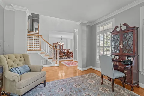 a living room with furniture fireplace and a large window