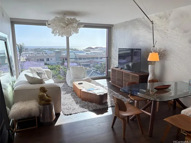 a living room with furniture and a floor to ceiling window