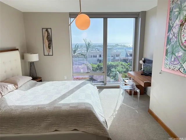 a bedroom with a large bed and a large window