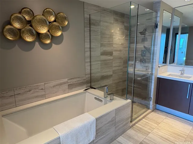 a bathroom with a tub sink and mirror