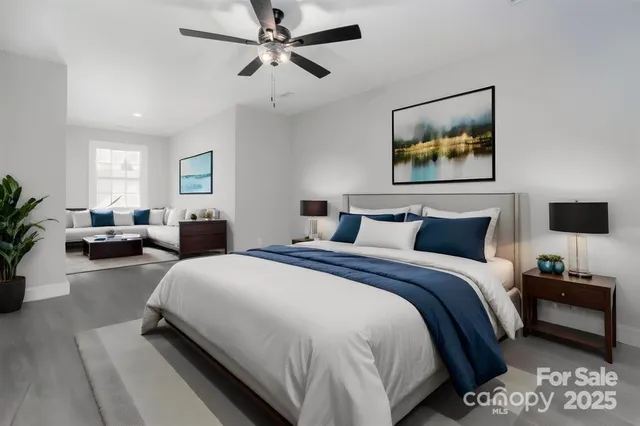 a bedroom with bed and a chandelier