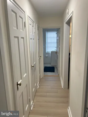 a view of a hallway with a wooden door