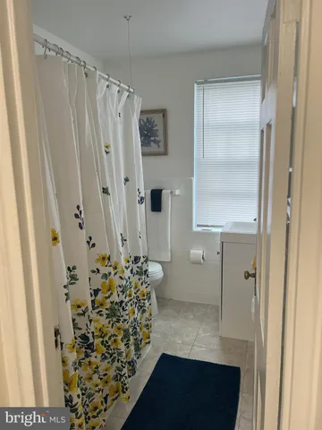 a bathroom with a shower and a mirror