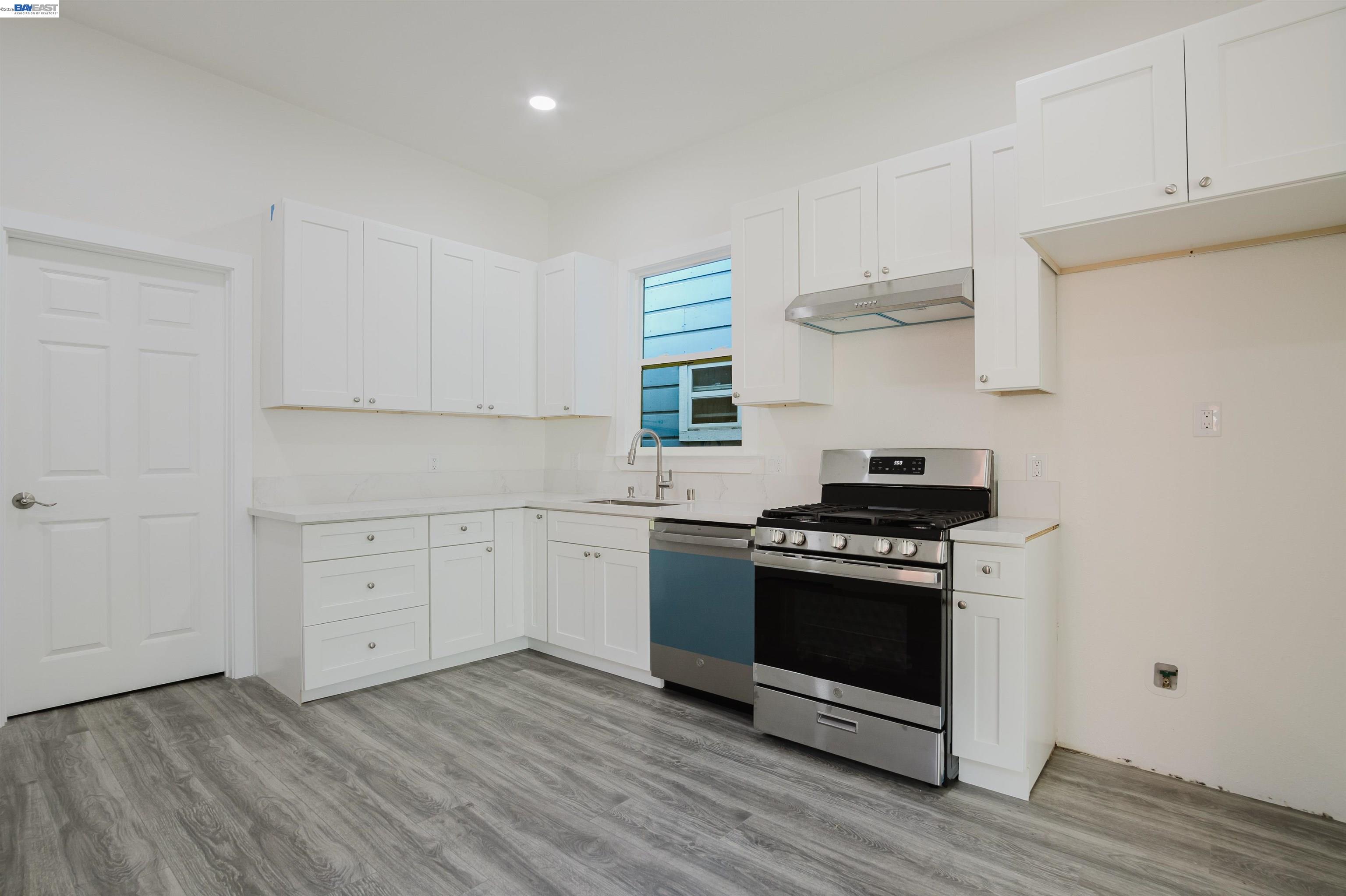 1778 8th Street Oakland, CA 94607 - Photo 4 of 36 a kitchen with cabinets appliances and wooden floor