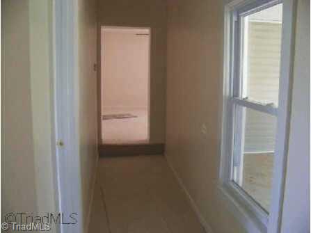 958 Buck Fork Road Dobson, NC 27017 - Photo 6 of 8 Other. Hallway has lots of natural light looking onto large front porch