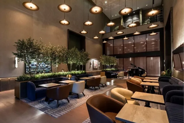 a living room with furniture a chandelier and a large window