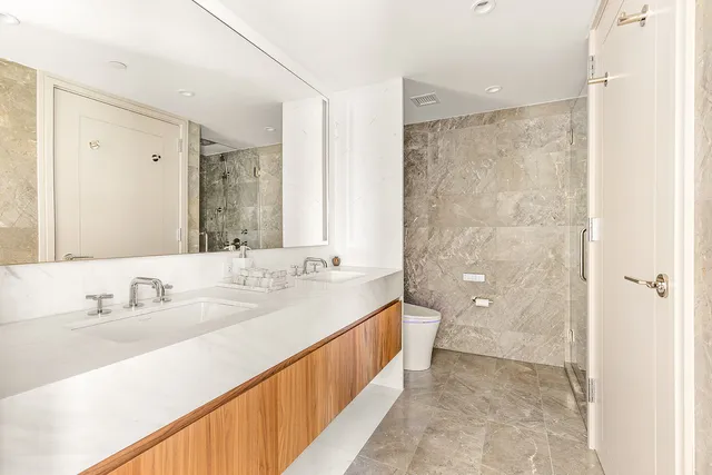 a spacious bathroom with a double vanity sink mirror double and shower