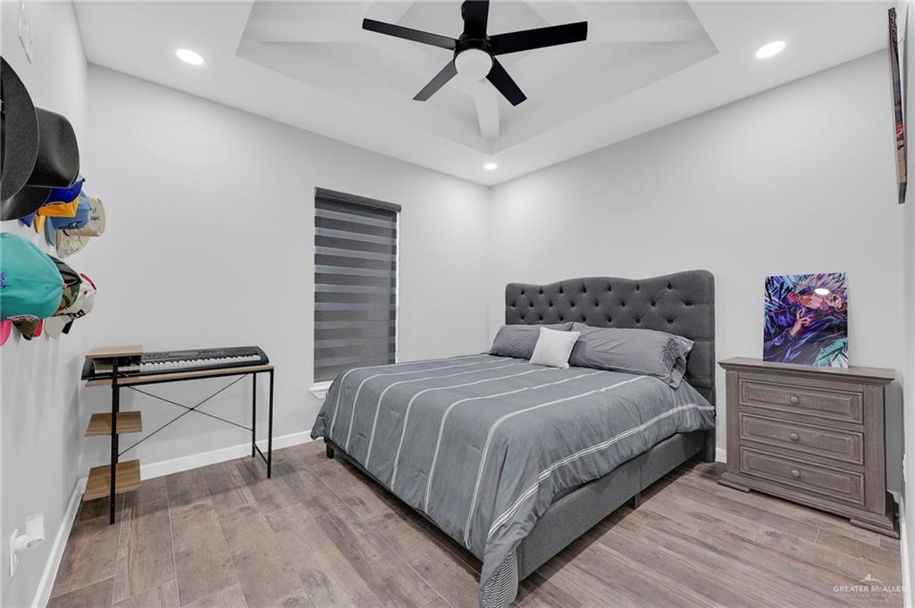 5284 North Mayberry Road Palmhurst, TX 78573 - Photo 11 of 26 a bedroom with a bed and a chandelier