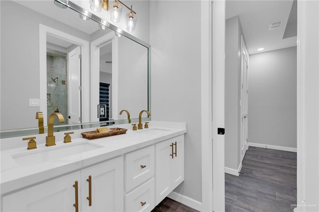 5284 North Mayberry Road Palmhurst, TX 78573 - Photo 14 of 26 a bathroom with a double vanity sink and a mirror