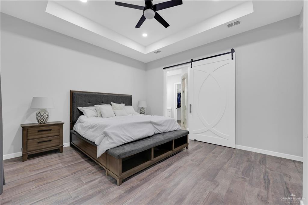 5284 North Mayberry Road Palmhurst, TX 78573 - Photo 17 of 26 a bedroom with a bed and a dresser