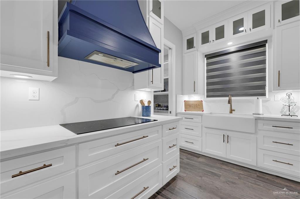 5284 North Mayberry Road Palmhurst, TX 78573 - Photo 3 of 26 a kitchen with white cabinets and sink