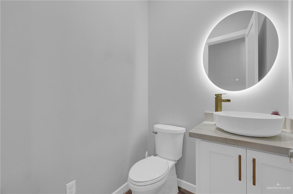 5284 North Mayberry Road Palmhurst, TX 78573 - Photo 10 of 26 a bathroom with a toilet and sink