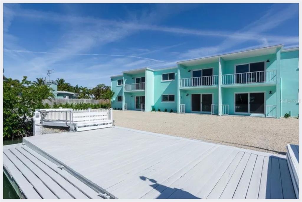 500 129th Avenue East, Unit 2 Madeira Beach, FL 33708 - Photo 15 of 16 front view of a house with a yard