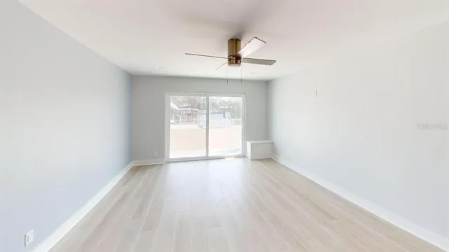 a kitchen with granite countertop a refrigerator and a stove top oven