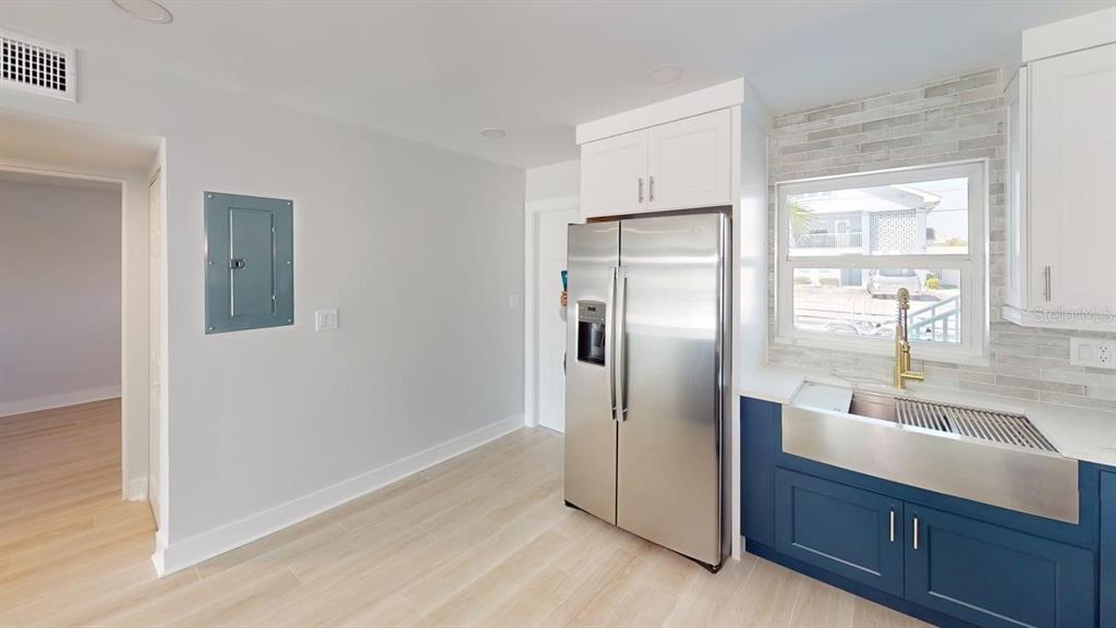 500 129th Avenue East, Unit 2 Madeira Beach, FL 33708 - Photo 6 of 16 a kitchen with stainless steel appliances granite countertop a refrigerator and a sink