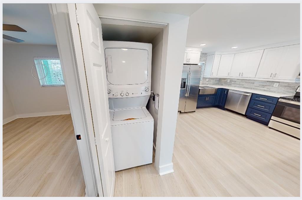 500 129th Avenue East, Unit 2 Madeira Beach, FL 33708 - Photo 7 of 16 a living room with furniture and a wooden floor