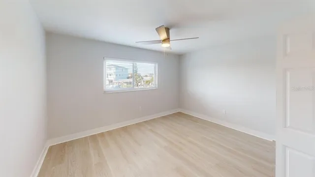 an empty room with windows and closet
