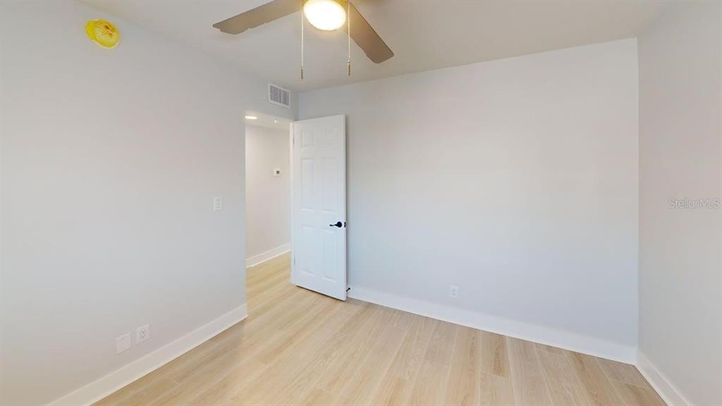 500 129th Avenue East, Unit 2 Madeira Beach, FL 33708 - Photo 10 of 16 wooden floor in an empty room