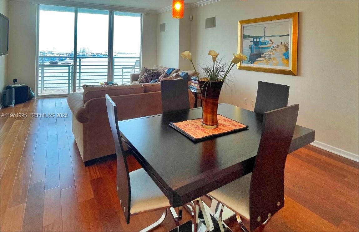 335 South Biscayne Boulevard, Unit 2212 Miami, FL 33131 - Photo 12 of 69 a view of a dining room with furniture window and wooden floor