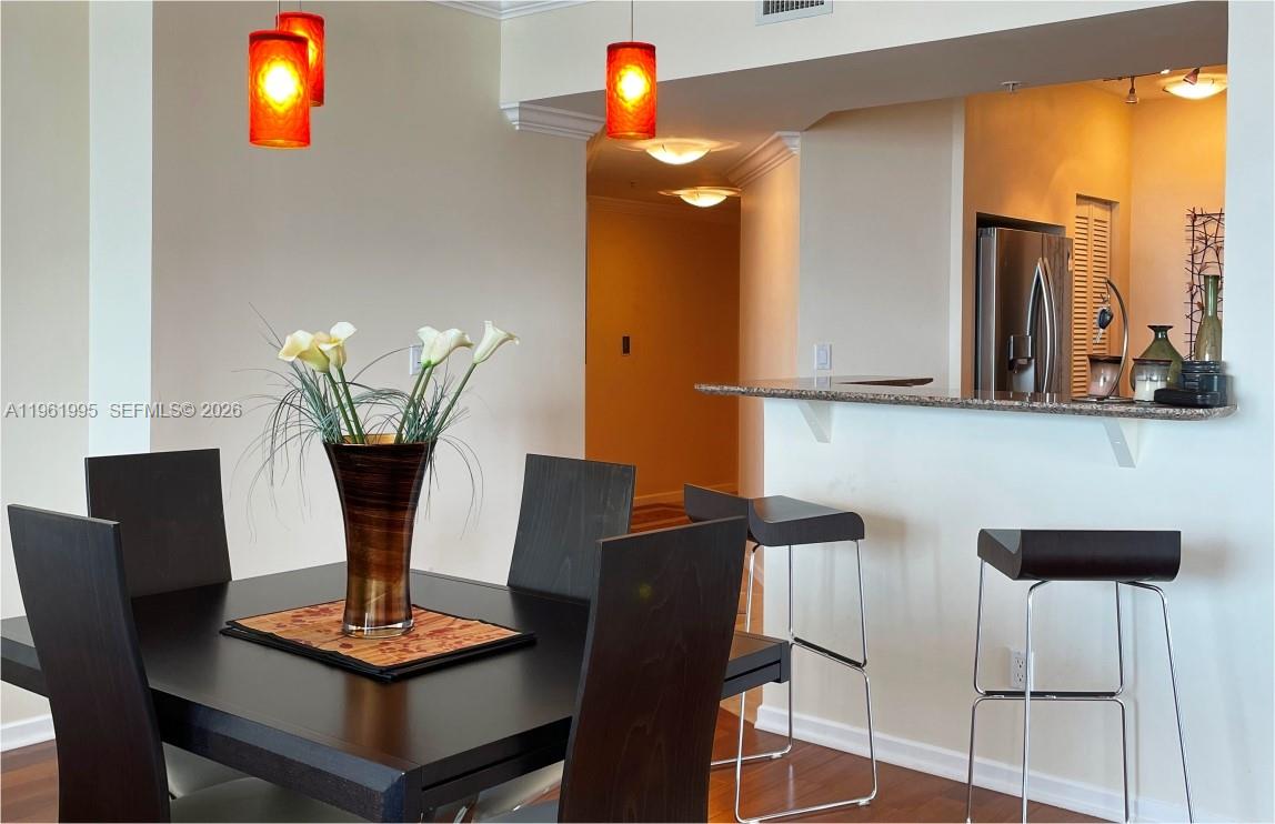 335 South Biscayne Boulevard, Unit 2212 Miami, FL 33131 - Photo 13 of 69 a dining room with furniture and wooden floor