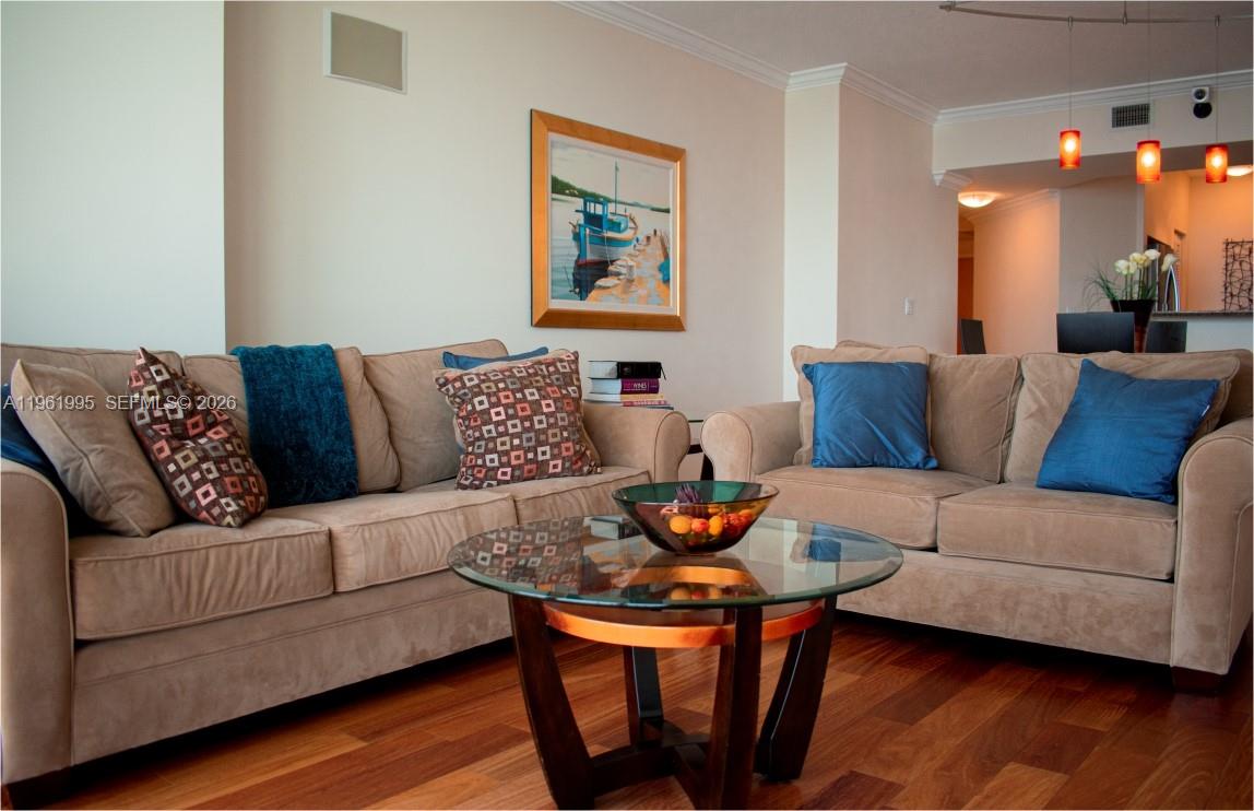 335 South Biscayne Boulevard, Unit 2212 Miami, FL 33131 - Photo 15 of 69 a living room with furniture and wooden floor