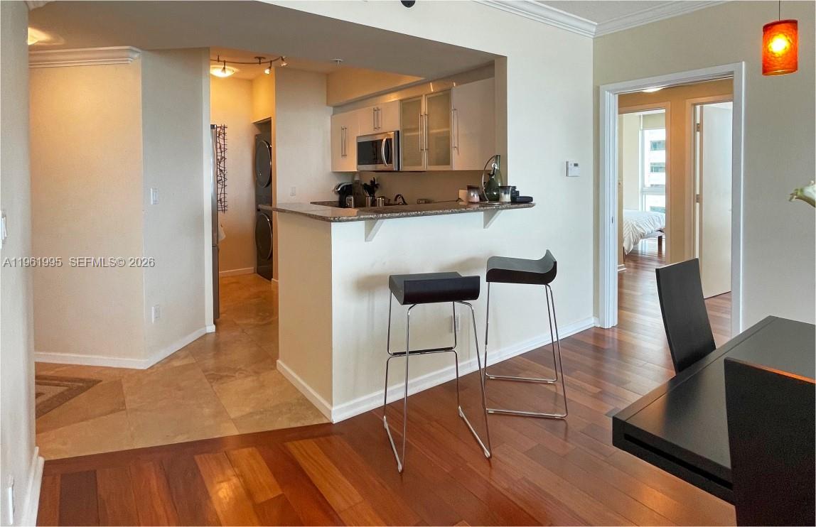 335 South Biscayne Boulevard, Unit 2212 Miami, FL 33131 - Photo 18 of 69 a kitchen with stainless steel appliances kitchen island granite countertop a refrigerator and microwave