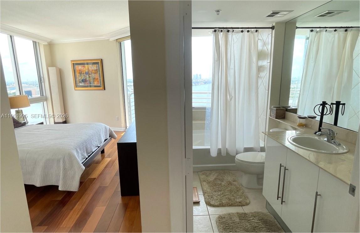 335 South Biscayne Boulevard, Unit 2212 Miami, FL 33131 - Photo 37 of 69 a en suite bathroom with a sink and a mirror