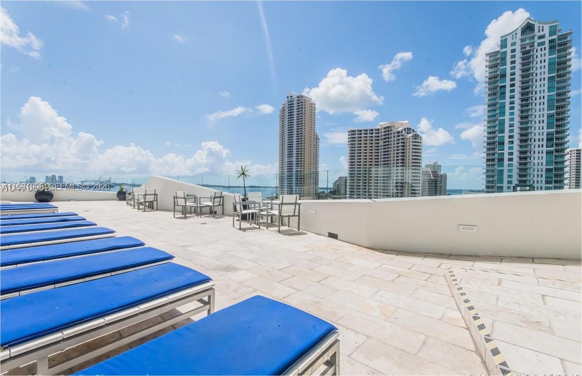 335 South Biscayne Boulevard, Unit 2212 Miami, FL 33131 - Photo 53 of 69 a swimming pool with outdoor seating and city view