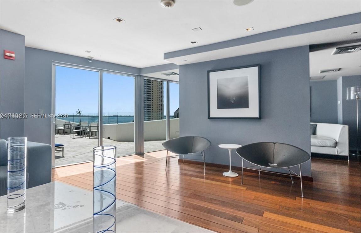 335 South Biscayne Boulevard, Unit 2212 Miami, FL 33131 - Photo 60 of 69 a living room with fireplace furniture and a large window