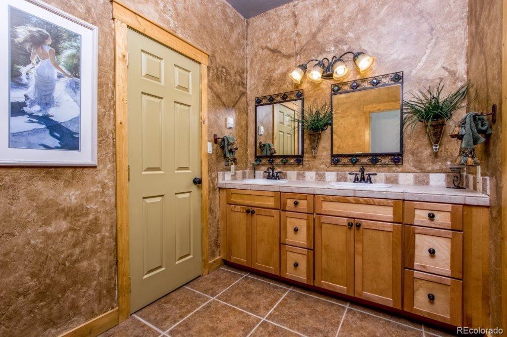 8044 Rossman Gulch Road Morrison, CO 80465 - Photo 12 of 34 a bathroom with a double vanity sink mirror and