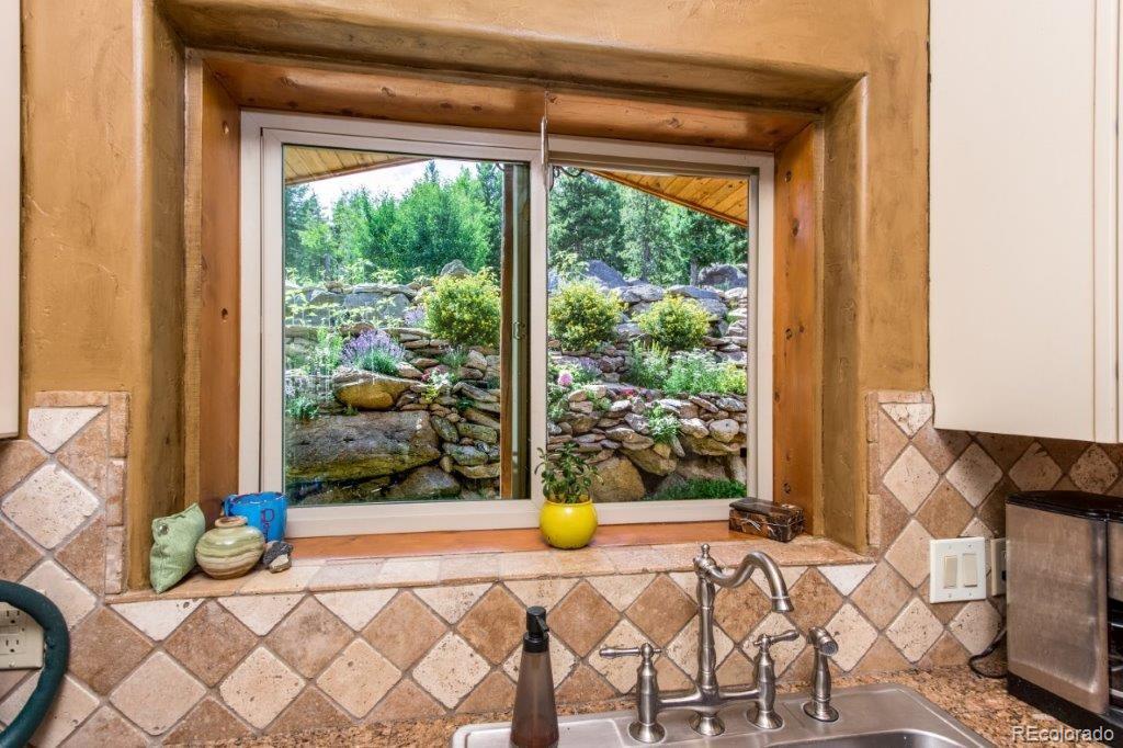 8044 Rossman Gulch Road Morrison, CO 80465 - Photo 17 of 34 a bedroom with a bed and a window