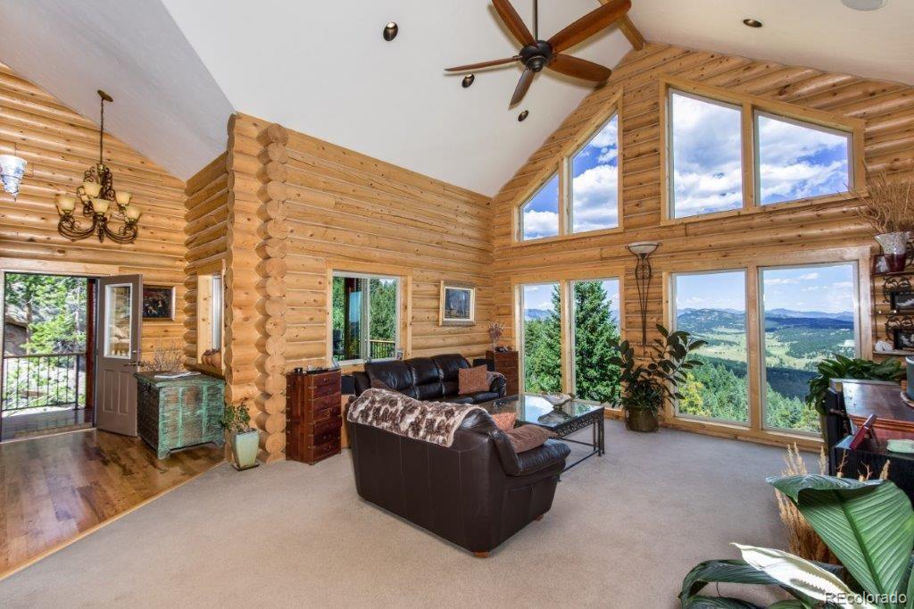 8044 Rossman Gulch Road Morrison, CO 80465 - Photo 19 of 34 a living room with furniture and floor to ceiling windows