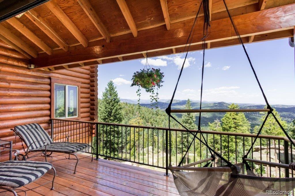 8044 Rossman Gulch Road Morrison, CO 80465 - Photo 22 of 34 a view of a balcony with furniture and wooden floor