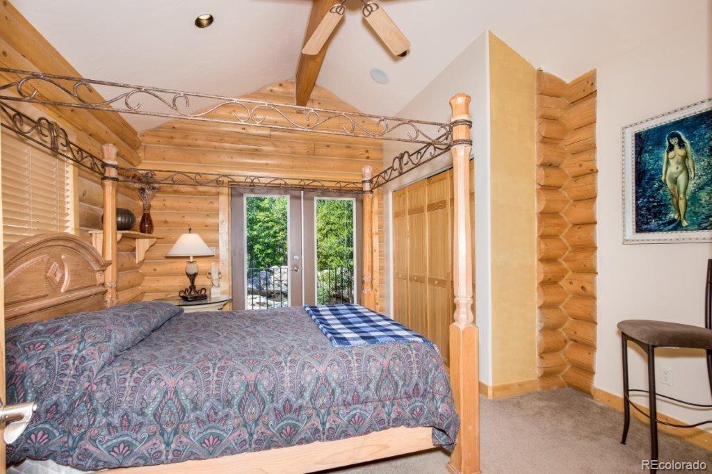 8044 Rossman Gulch Road Morrison, CO 80465 - Photo 27 of 34 a bed sitting in a room next to a window