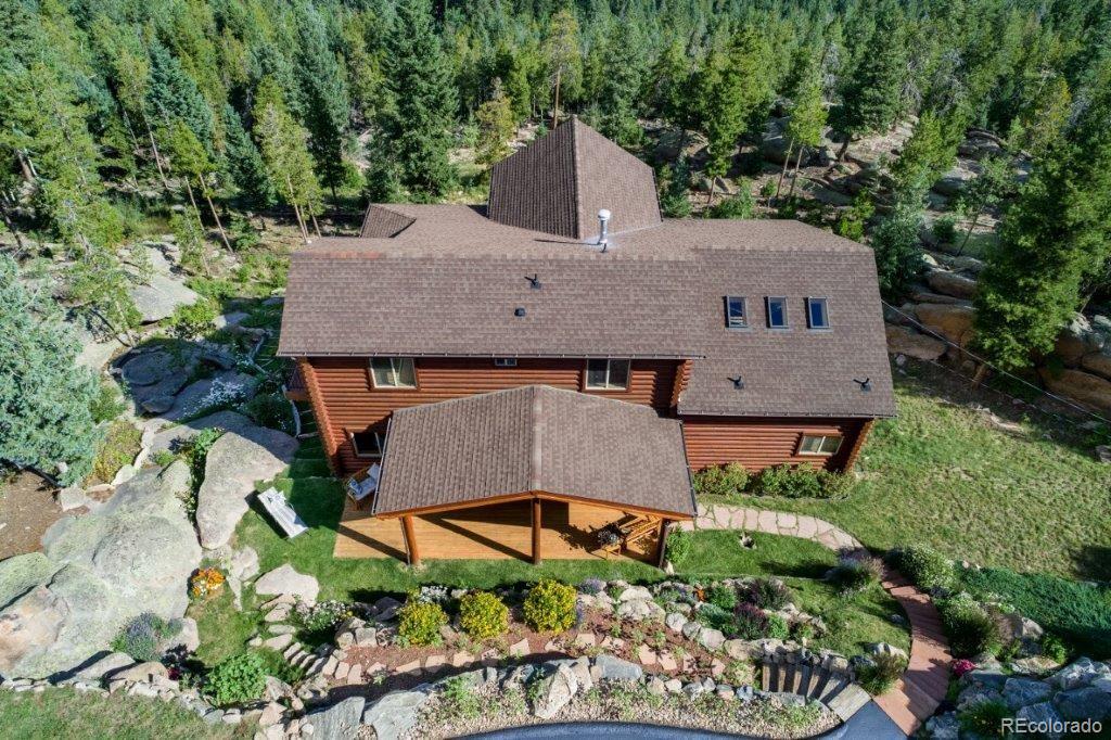 8044 Rossman Gulch Road Morrison, CO 80465 - Photo 5 of 34 an aerial view of a house with yard and trees in the background