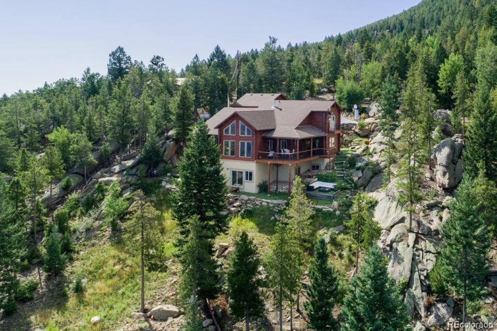 8044 Rossman Gulch Road Morrison, CO 80465 - Photo 6 of 34 a aerial view of a house with yard and trees in the background
