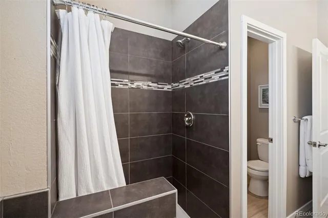 a bathroom with a shower and a mirror