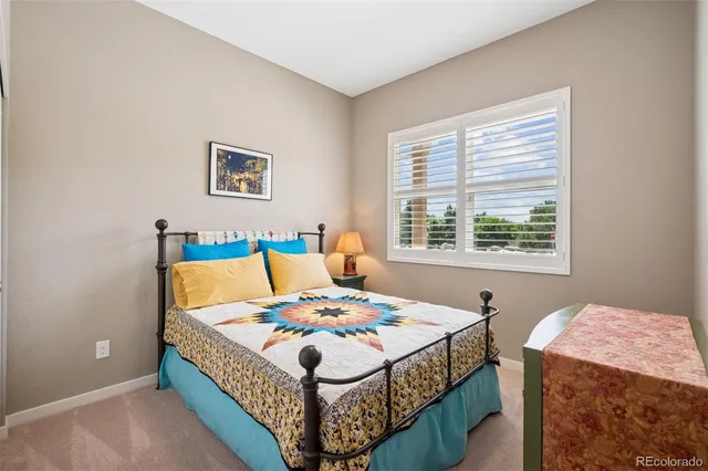 a bedroom that has a bed and a table in it