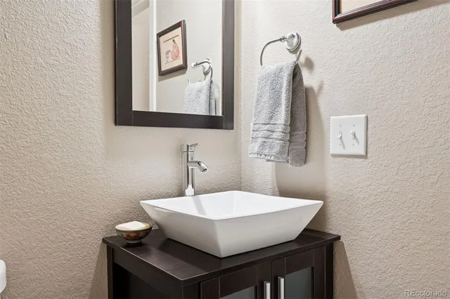 a bathroom with a sink a mirror and a toilet