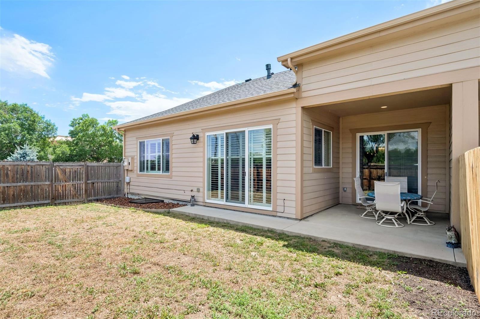 5795 Xenon Way Arvada, CO 80002 - Photo 29 of 33 a view of a house with backyard and sitting area