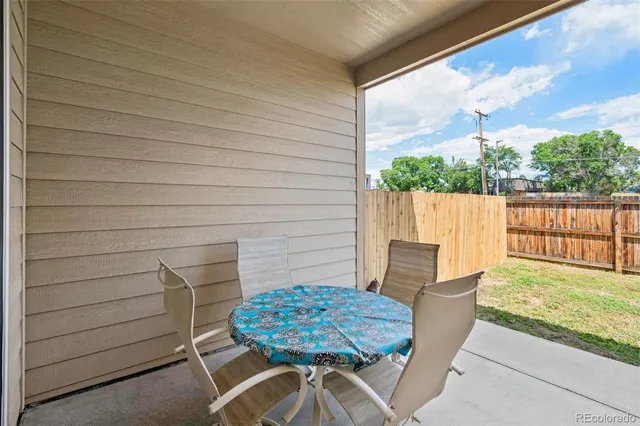 a view of a chairs and table in patio