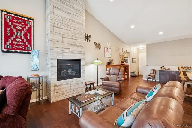 a living room with furniture fireplace and rug