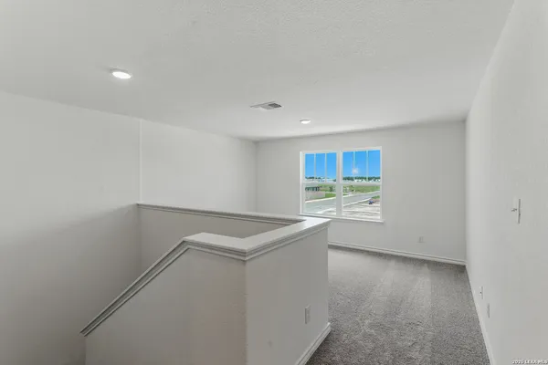 a view of storage and utility room with wooden floor