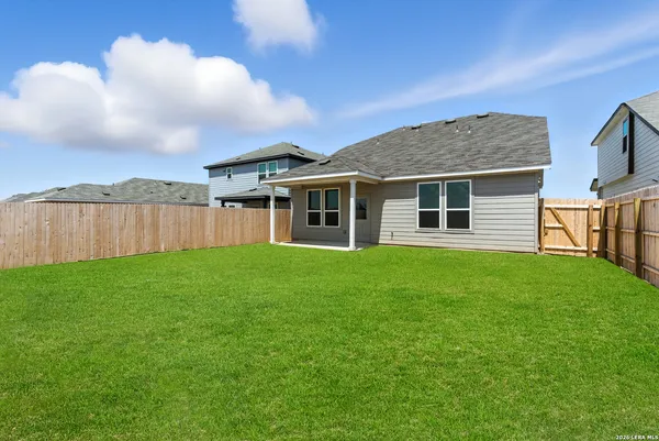 a view of a house with a backyard