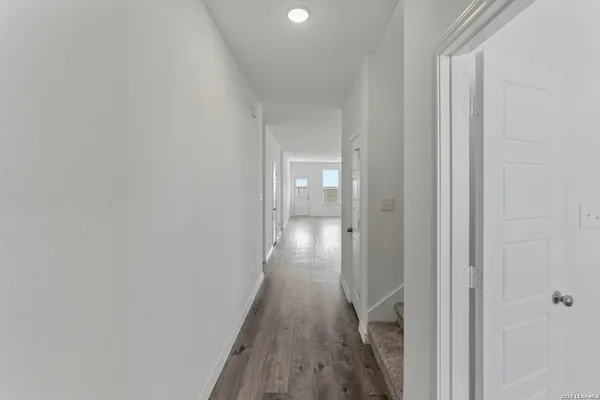 a view of hallway with wooden floor