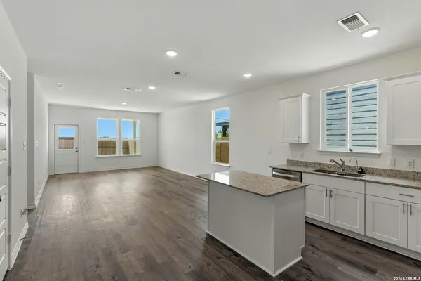 a kitchen with stainless steel appliances granite countertop a sink stove and cabinets