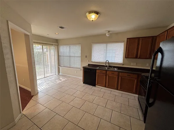 a kitchen with stainless steel appliances a sink stove and cabinets