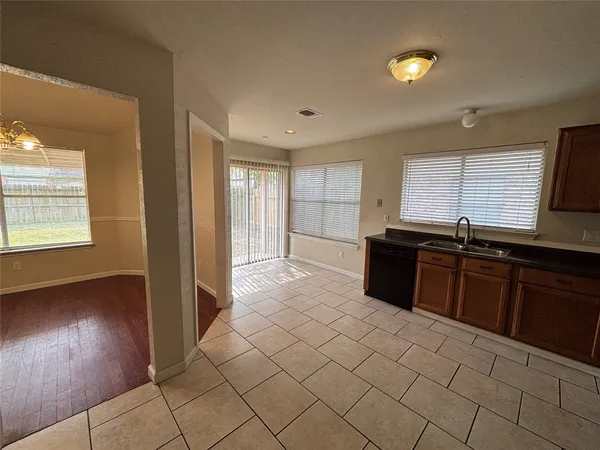 a large kitchen with a stove a sink and a refrigerator