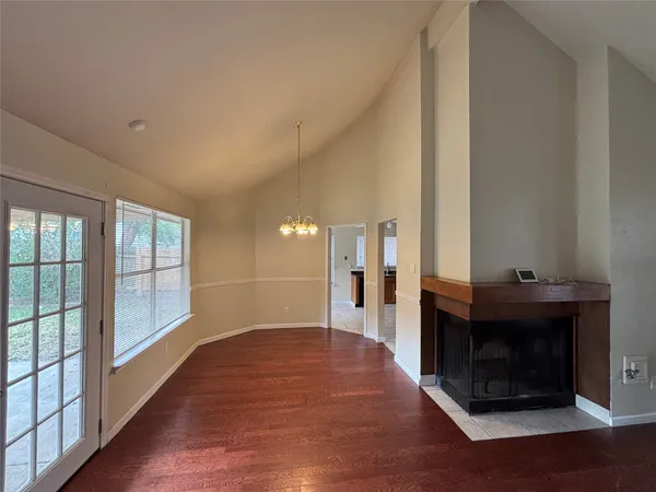 a living room with a fireplace and a large window